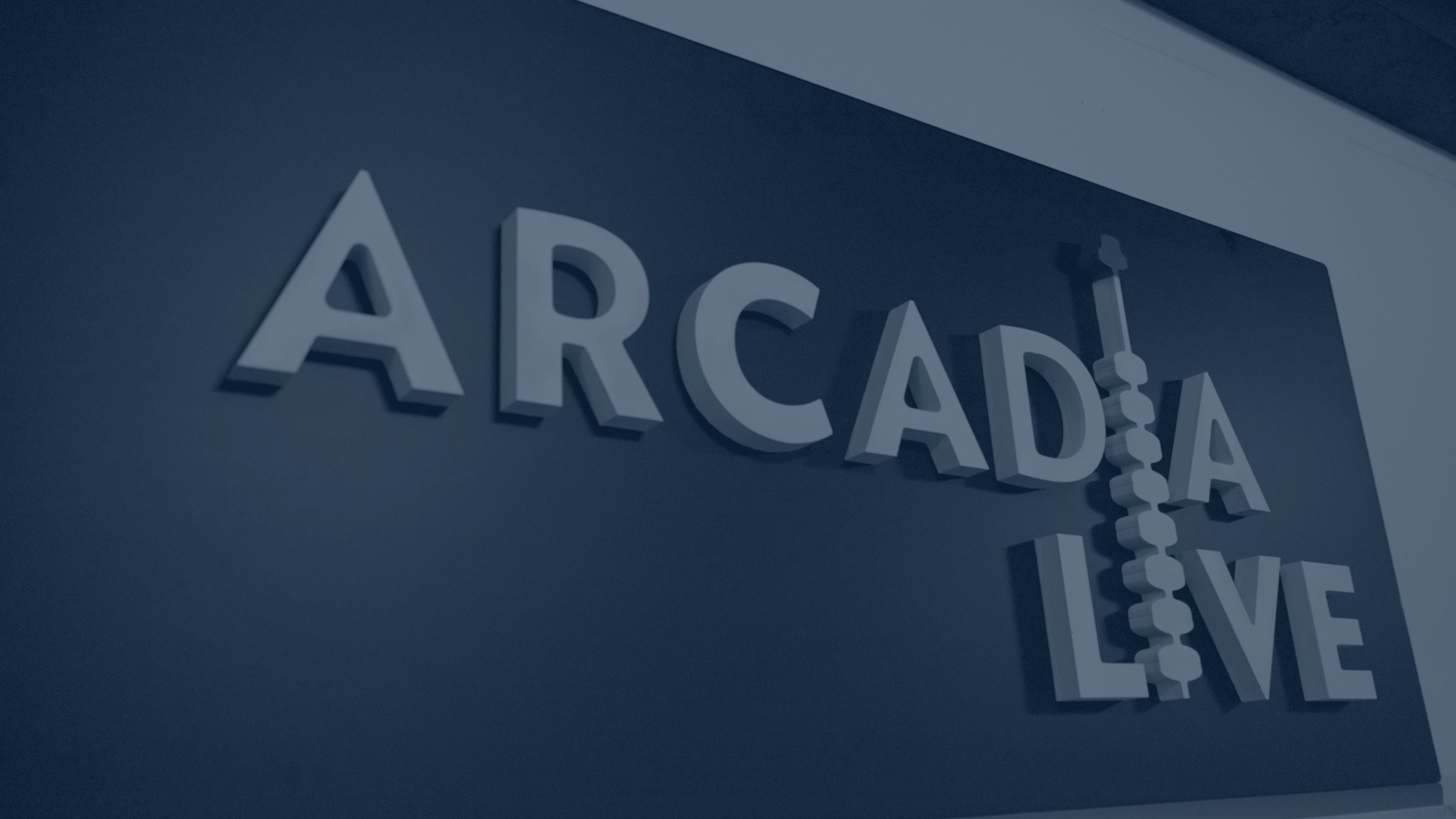 Arcadia Live sign in Kerrville, in focus with a soft radial fade around the image